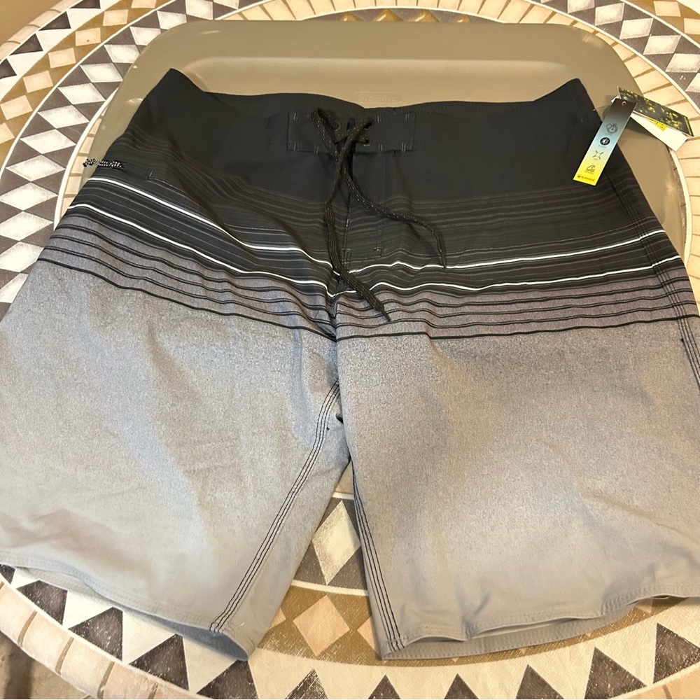 Men’s black and gray swim trunks with pocket.
